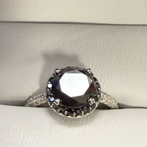 One Beautiful Black round cut diamond with a high polish finish.